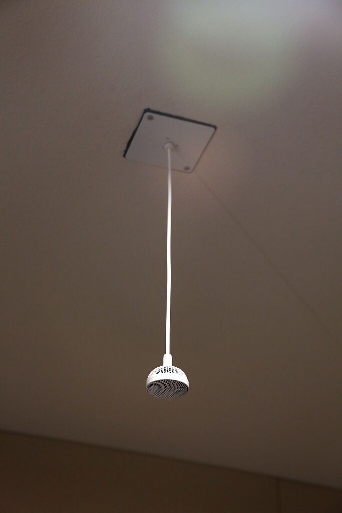 A microphone hangs from the ceiling